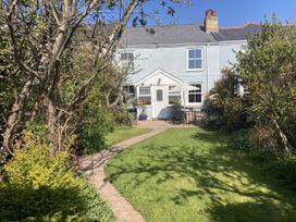 A garden with a house and seating area at 5 Bed Cottage Mumbles in Mumbles