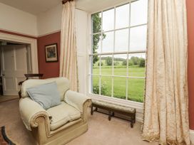 A living room with an armchair and window at Westward Park in Westward near Wigton