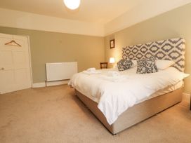 A bedroom with a bed and a wardrobe at Westward Park in Westward near Wigton