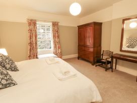 A bedroom with a bed and window at Westward Park near Wigton