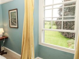 A bedroom with a window and lamp at Westward Park near Wigton
