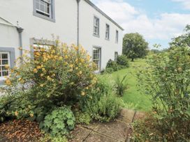 A garden with flowers and a house at Westward Park in Westward near Wigton