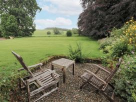 A garden with two chairs and a table at Westward Park near Wigton