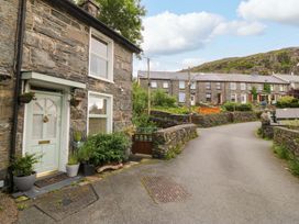 A stone house with a front door and plants at Waterfall Retreat in Blaenau Ffestiniog