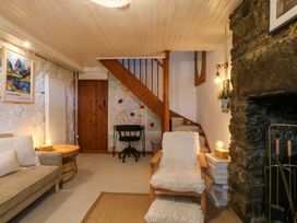 A living room with a sofa and fireplace at Waterfall Retreat in Blaenau Ffestiniog