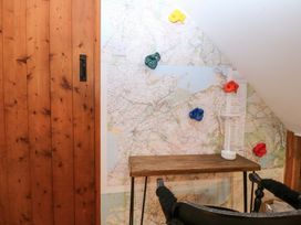 A climbing area with wall mounted holds and a table at Waterfall Retreat in Blaenau Ffestiniog