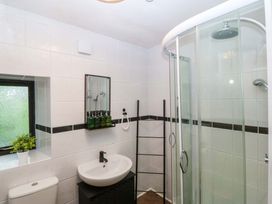 A bathroom with a shower, toilet, and sink at Waterfall Retreat in Blaenau Ffestiniog