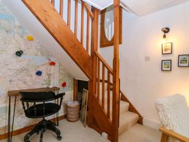 A staircase with wall decor and furniture at Waterfall Retreat in Blaenau Ffestiniog