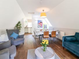 A living room with a dining table and chairs at Valley Lodge 37, St Ann's Chapel, Cornwall