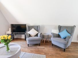 A living room with two armchairs and a television at Valley Lodge 37 St Ann's Chapel, Cornwall