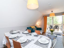 A dining room with a table set for dinner at Valley Lodge 37 St Ann's Chapel, Cornwall