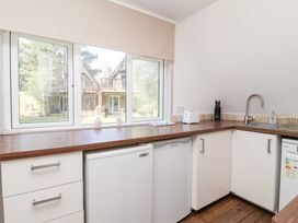 A kitchen with a sink and fridge at Valley Lodge 37 St Ann's Chapel, Cornwall