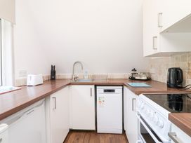 A kitchen featuring a sink, stove and dishwasher at Valley Lodge 37, St Ann's Chapel, Cornwall