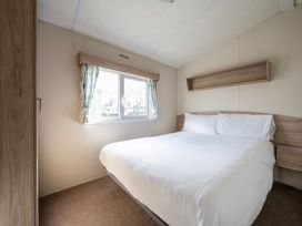 A bedroom with a double bed and window at Ripples & Reeds - Billing Aquadrome
