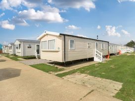 A static caravan with a pathway and grass at Ripples & Reeds - Billing Aquadrome