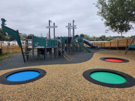 A playground with climbing structure and slides at Ripples & Reeds - Billing Aquadrome