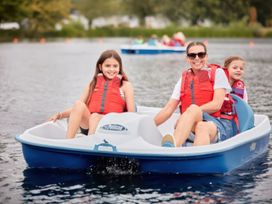 A family in a boat on water at Ripples & Reeds - Billing Aquadrome
