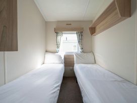 A bedroom with two beds and a window at Duckling Den - Billing Aquadrome