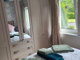 A bedroom with a bed and towels on the bedside at Beech Lodge in Foulksmills, County Wexford
