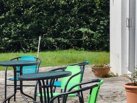 An outdoor seating area with tables and chairs at Beech Lodge, Foulksmills, County Wexford