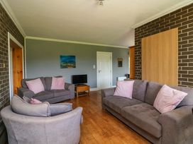 A living room with sofas and a television at Beech Lodge, Foulksmills, County Wexford