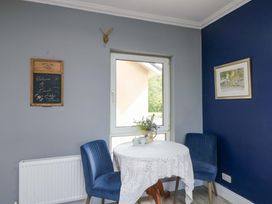 A dining area with a table and chairs at Beech Lodge in Foulksmills County Wexford