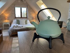 A kettle on a table in a bedroom at Pheasants Rise Apartment in Ross-On-Wye