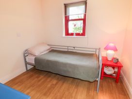 A bedroom with a single bed and a nightstand at Shane's Cottage Falcarragh, County Donegal