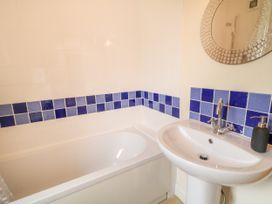 A bathroom with a bathtub and sink at Shane's Cottage Falcarragh County Donegal