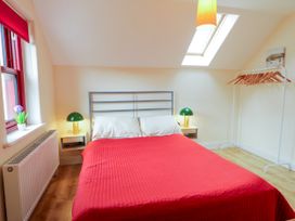 A bedroom with a bed and nightstand at Shane's Cottage, Falcarragh, County Donegal
