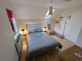 A bedroom with a bed and a bedside lamp at Shane's Cottage in Falcarragh, County Donegal