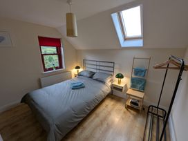 A bedroom with a bed and bedside table at Shane's Cottage in Falcarragh, County Donegal