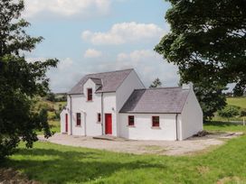 A house with red accents and a gravel area at Shane's Cottage, Falcarragh, County Donegal