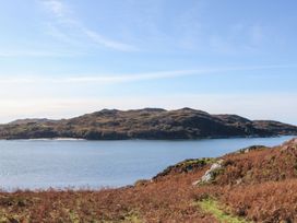 A body of water with hills and vegetation in the background at Creag Mhor Lodge Back of Keppoch near Arisaig
