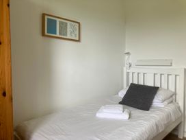 A bedroom with a bed and wall art at Island View Lodge, Back of Keppoch near Arisaig