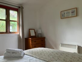 A bedroom with a bed and a chest of drawers at Island View Lodge in Back of Keppoch near Arisaig