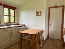 A kitchen with a sink and a table at Island View Lodge Back of Keppoch near Arisaig