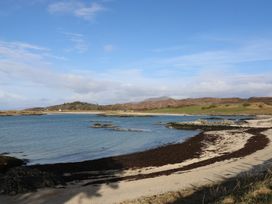 A beach scene with water and rocks at Island View Lodge Back of Keppoch near Arisaig