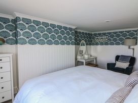 A bedroom with a bed and dressing table at 43 The Salcombe in Salcombe