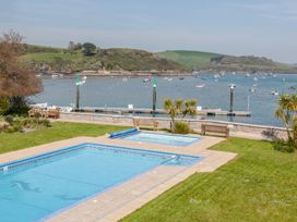 A swimming pool and boats on the water at 43 The Salcombe in Salcombe