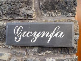 A stone wall with a black sign that reads Gwynfa at Gwynfa in Ysbyty Ifan