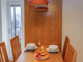 A dining table set with bowls plates croissants raspberries and glasses of orange juice at Apartment 3 in Scarborough