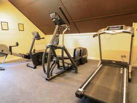 A small gym room with a treadmill elliptical machine and rowing machine at Millers Loft in Modbury