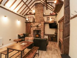 A living room with a fireplace and television at Dotty's Den in Bridlington