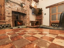 A snug with a fireplace and a table at Dotty's Den in Bridlington