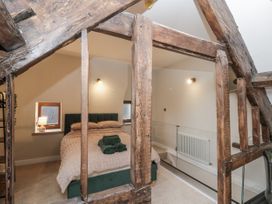 A bedroom with a bed and windows at Dotty's Den in Bridlington