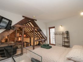 A bedroom with a bed and television at Dotty's Den in Bridlington