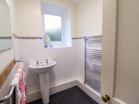 A bathroom with a sink and a heated towel rail at Garth Celyn in Porthmadog