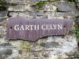 A sign that reads Garth Celyn on a stone wall at Garth Celyn, Porthmadog