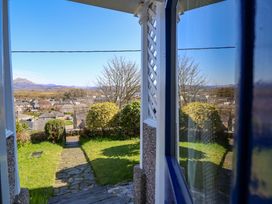 A view from a window showing a garden and hills at Garth Celyn Porthmadog